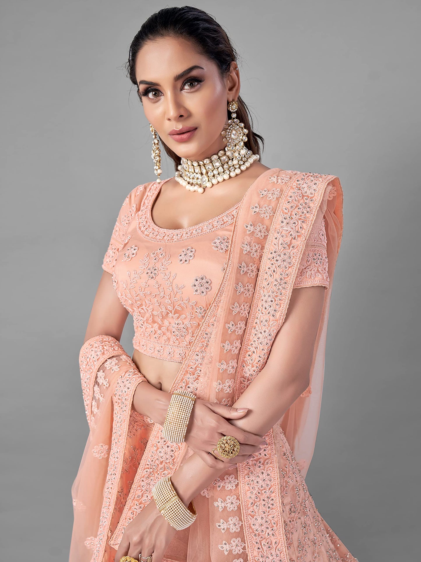 FUSIONIC Peach Color Soft Net Material Stone Work Lehenga Choli For Women