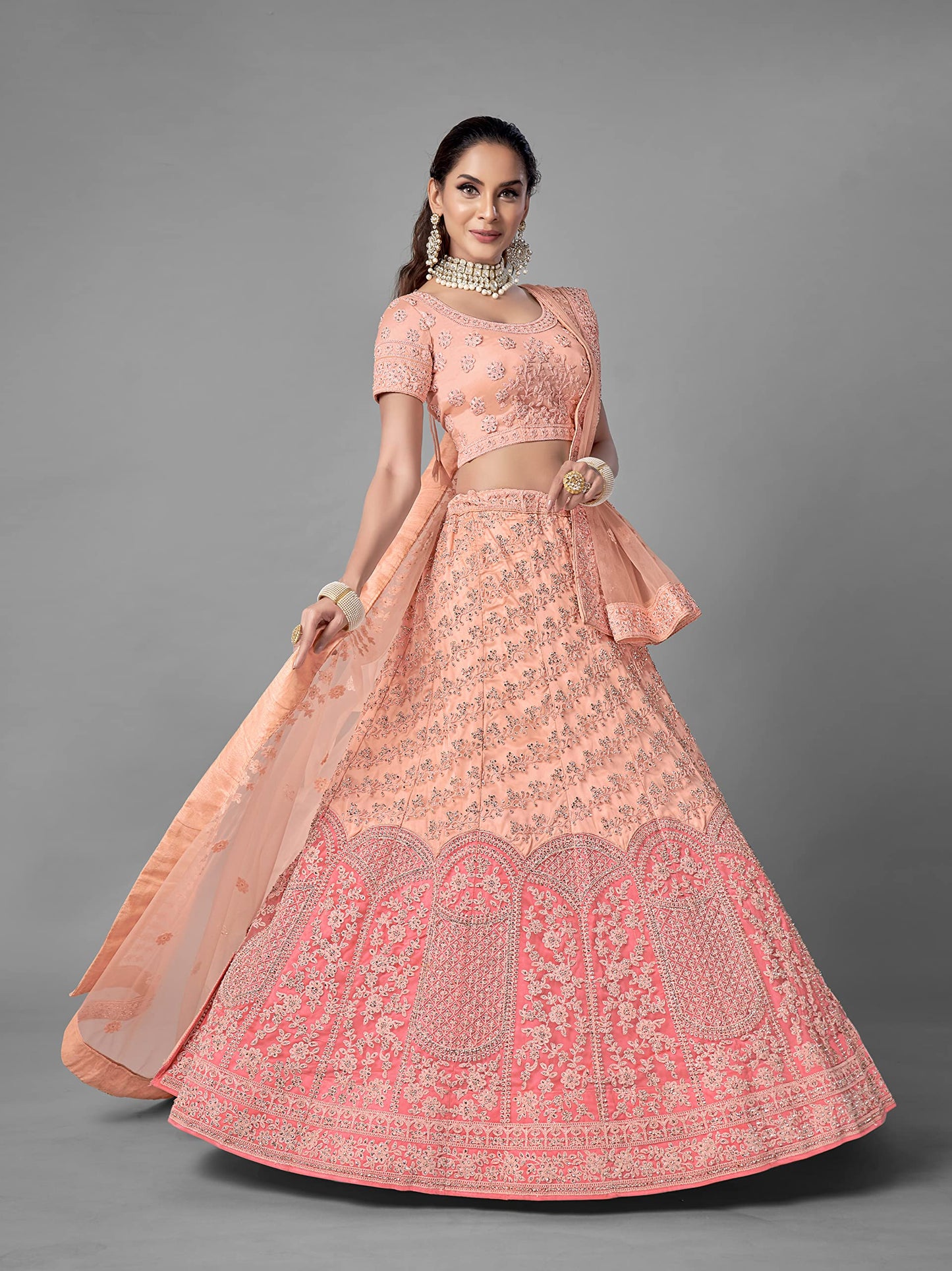 FUSIONIC Peach Color Soft Net Material Stone Work Lehenga Choli For Women